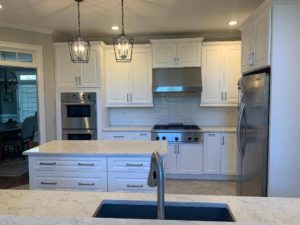 Picture of kitchen looking at oven and granite counters