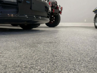Photo of garage floor with the bumper of a car in the corner
